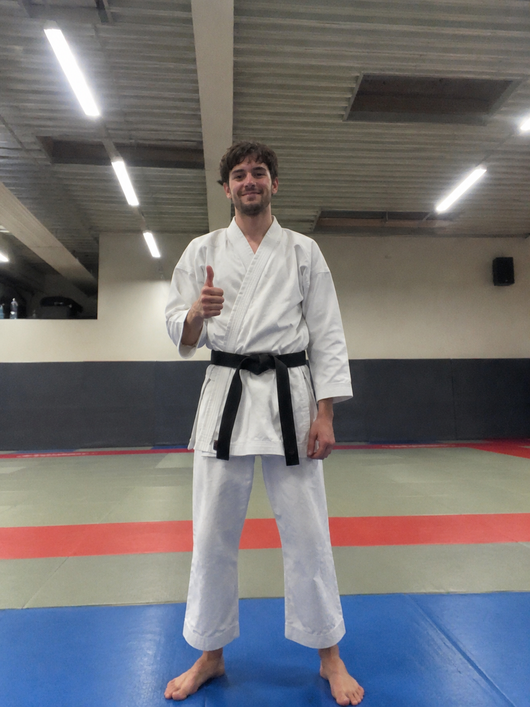 Karate instructor wearing a white gi and black belt
